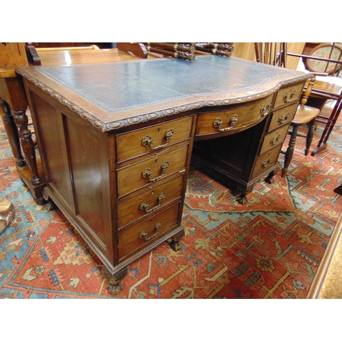 410 - Leather topped desk, bow front, having three short drawers with further drawers to either side, on c... 