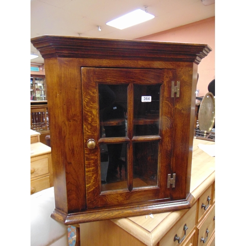 364 - Reproduction oak corner cupboard, ogive cornice above glazed beaded panel door enclosing a shelf lin... 