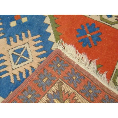 112 - Red and blue ground rug, having geometric pattern, 71 x 49