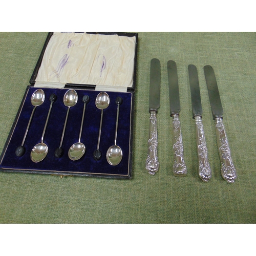 206 - Four Silver handled butter knives together with a cased set of silver coffee spoons.