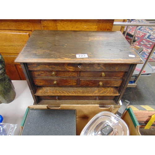 223 - Stained oak table top chest, lift-up lid, five drawers and knob handles. 11 x 16.5 x 10