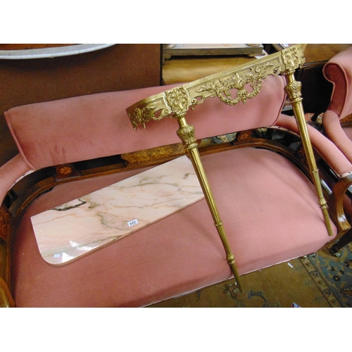 324 - Ornate gilt metal pier table, pink marble top, on fluted turned frontal supports. 32 x 28 x 9.5