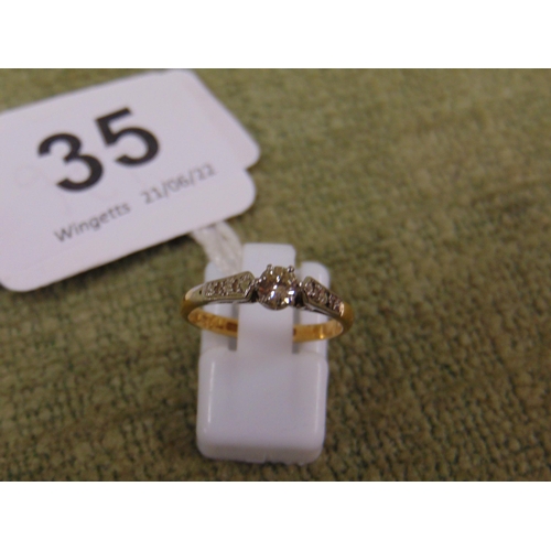 35 - 18ct gold and platinum solitaire diamond ring with diamond chips to the shoulders, size K, 2.6g.