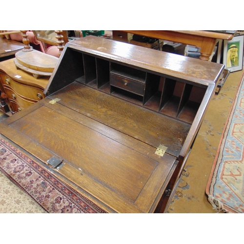 373 - Reproduction oak bureau, linen fold front revealing a fitted interior, above single long drawer and ... 