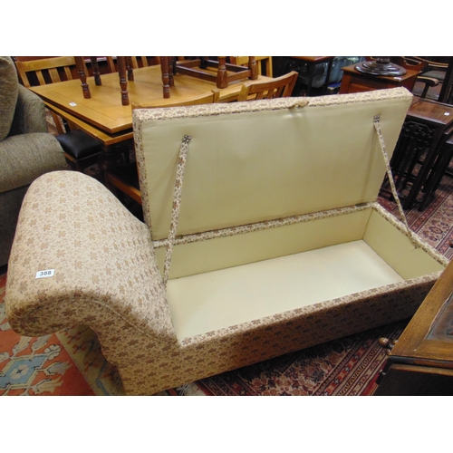 388 - Floral upholstered day bed, lift up seat and on castors. 63