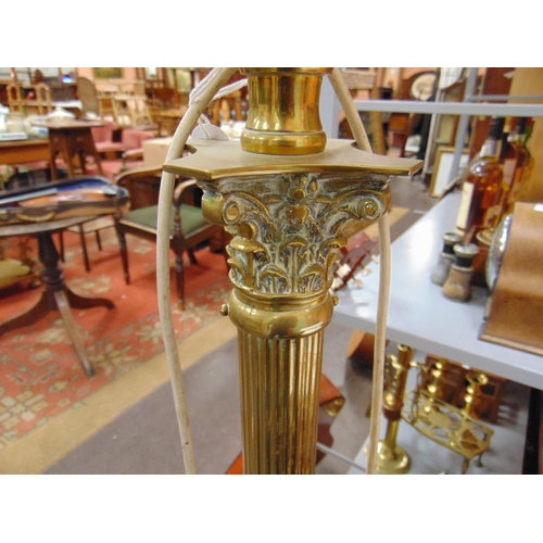 512 - Gilt metal  rise and fall standard lamp with shade.