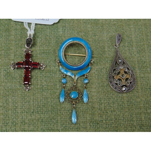 53 - Silver and enamel brooch, garnet crucifix, and a silver and marcasite pendant.