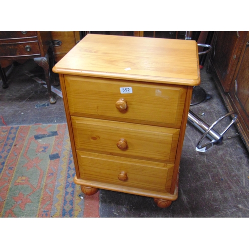 351 - Modern pine bedside chest of three drawers with knob handles.