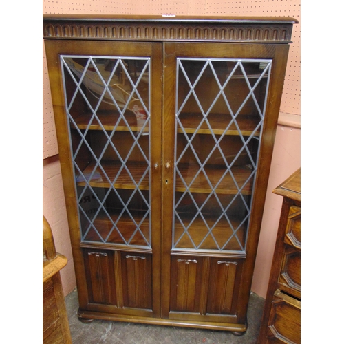 354 - Reproduction oak side cabinet, pair of leaded glazed doors, shelf lined interior above linen fold de... 