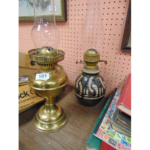 101 - Brass oil lamp and a studio pottery oil lamp.