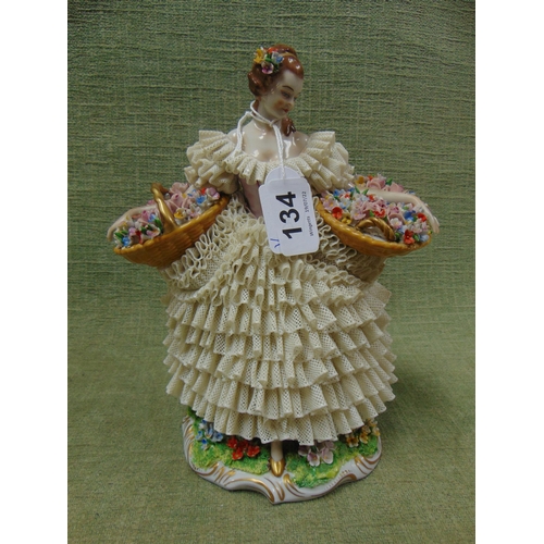 134 - Sitzendorf porcelain figure of a lady in crinolene dress with baskets of flowers.