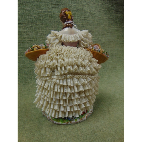 134 - Sitzendorf porcelain figure of a lady in crinolene dress with baskets of flowers.