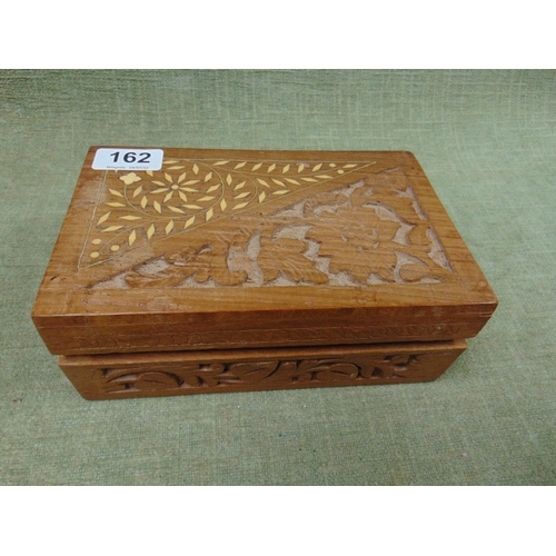 162 - Carved wooden box containing badges etc.