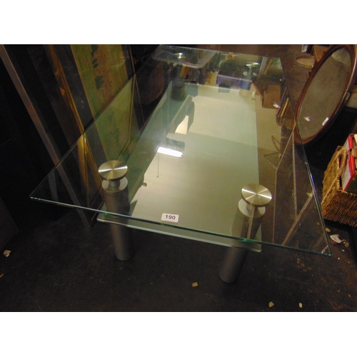 190 - Contemporary glass topped coffee table, on cylindrical supports. 10 x 51 x 27.5