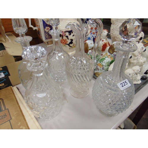 225 - Four cut glass decanters and one other (5).