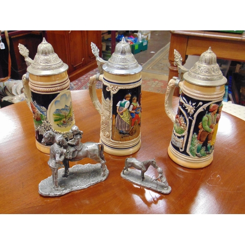 263 - Three small steins, and two pewter figure groups.