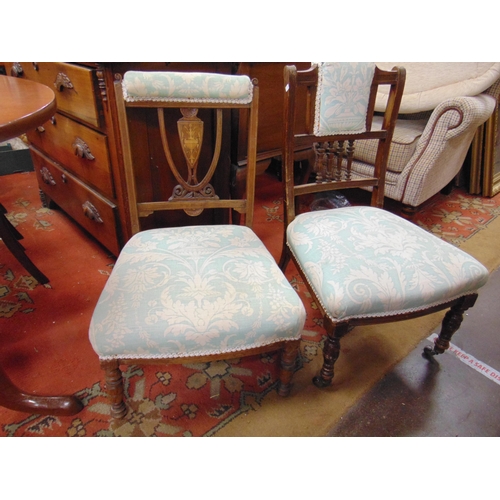 296 - Two  Edwardian nursing chairs, upholstered backs and seats, on turned frontal supports.