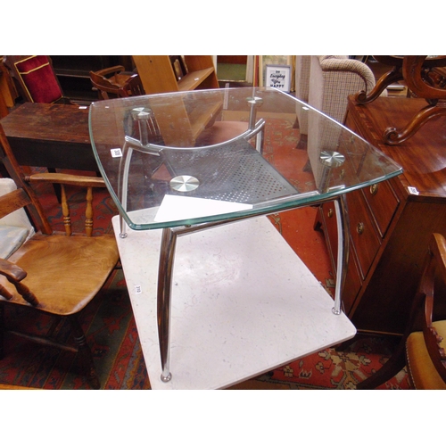 308 - Contemporary glass topped table, set on tapered supports. 20.5