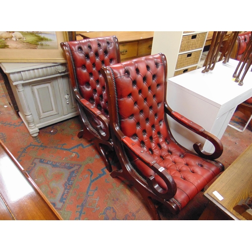 324 - Pair of antique style library chairs, having red leather button back upholstery, scroll arms and on ... 