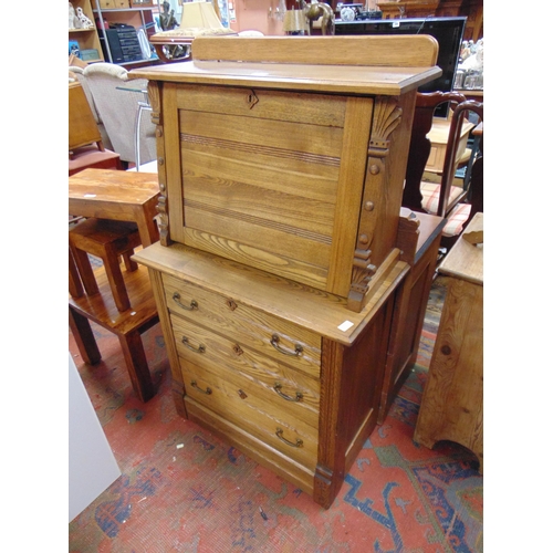 325 - An oak secretaire a abattant, fall front revealing a fitted interior, three long drawers with metal ... 