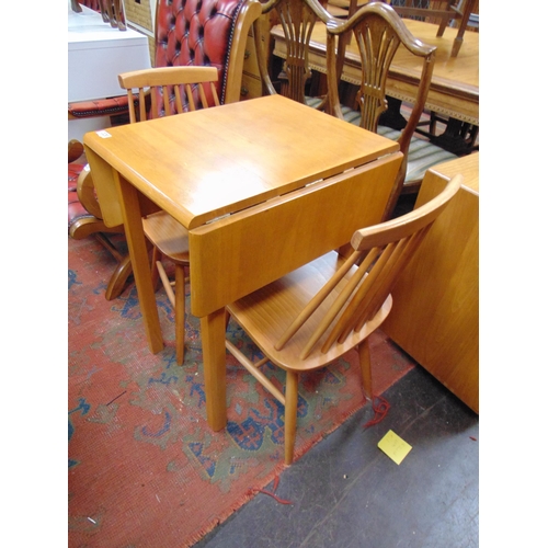 329 - Small drop leaf table and a pair of stick back chairs.