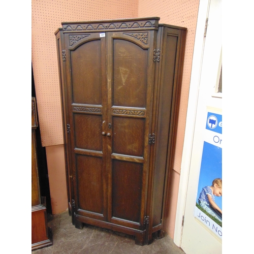 365 - Reproduction oak hanging corner cupboard, having pair of panel doors. 71 x 41