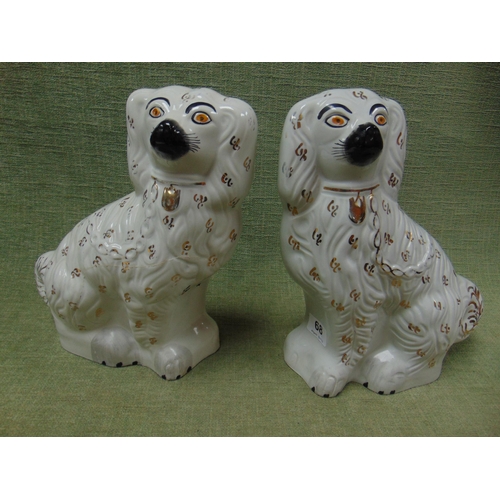 68 - Pair of Staffordshire seated Spaniels.