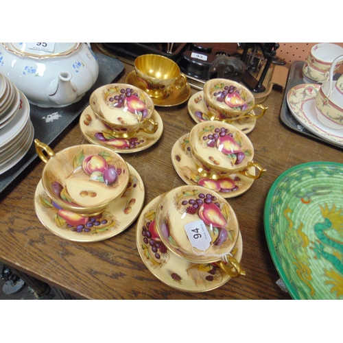 94 - Six Aynsley cups and saucers, decorated with fruit and signed N. Brunt.