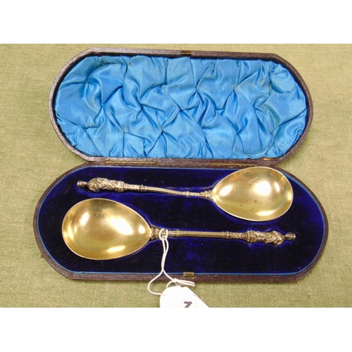 15 - Cased pair of antique gilt anointing spoons.