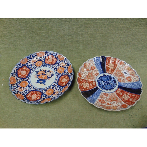 158 - Two late 19th century circular Imari dishes with traditional decoration and scalloped rims, 12