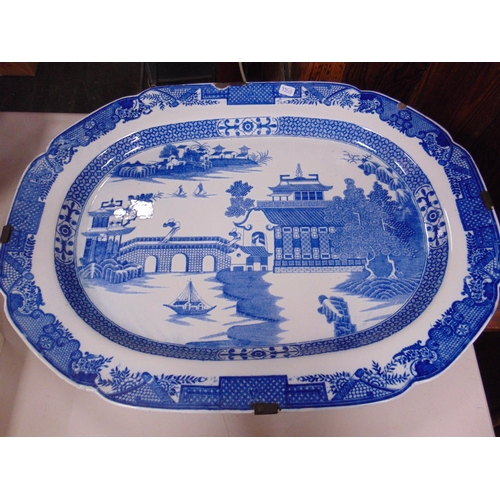 226 - Antique glazed blue and white meat plate, together with a similar willow pattern example. (2).