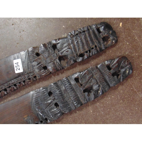 254 - Pair of carved native wooden swords.