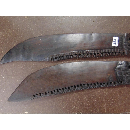 254 - Pair of carved native wooden swords.