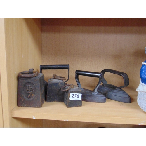 278 - Various antique weights and three flat irons.