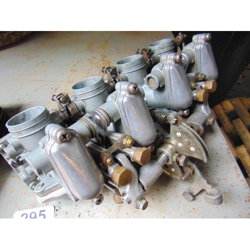 295 - Set of carburettors from a four cylinder Japanese motor cycle and a twin cylinder barrel. (2).