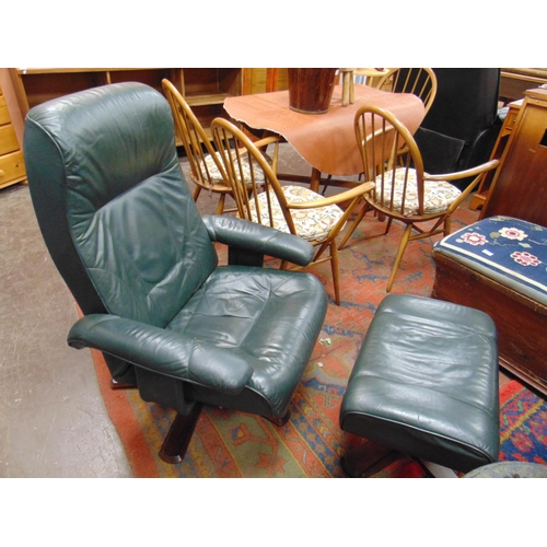 488 - Green leather swivel chair and matching stool.