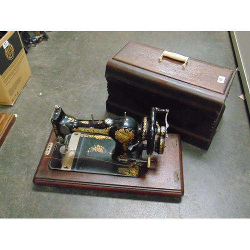 60 - Jones' manual sewing machine in case.