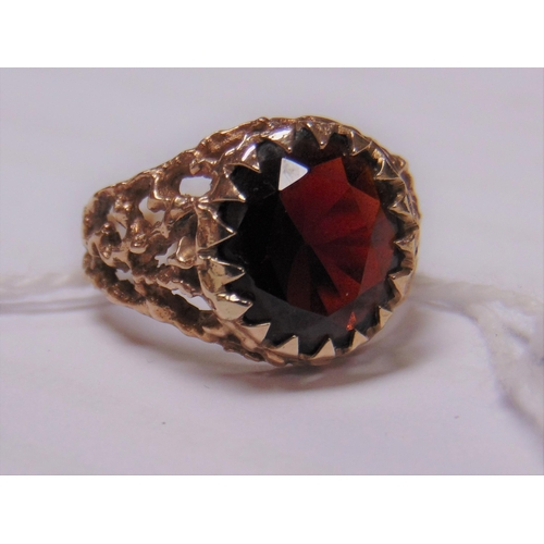 10 - 9ct yellow gold ring with pierced shoulders, set with a large garnet, size N, 4.3g.