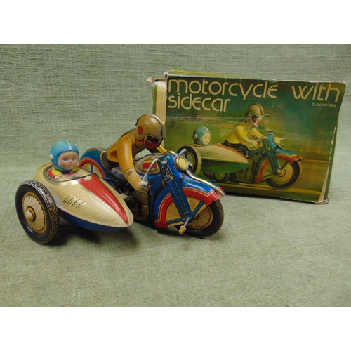 146 - Boxed tinplate clockwork motorcycle with sidecar.