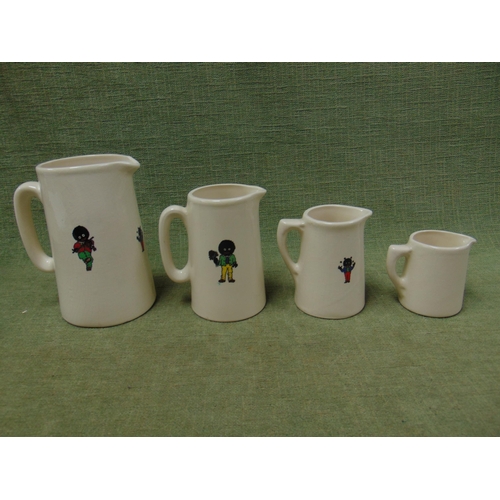 149 - Set of four graduated Staffordshire jugs decorated with Golliwogs.