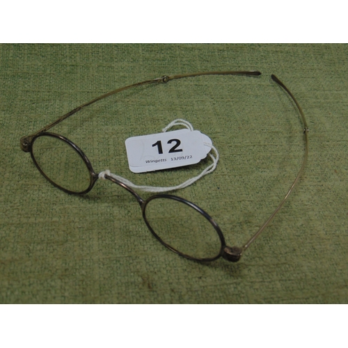 12 - Pair of antique silver framed spectacles with folding arms.