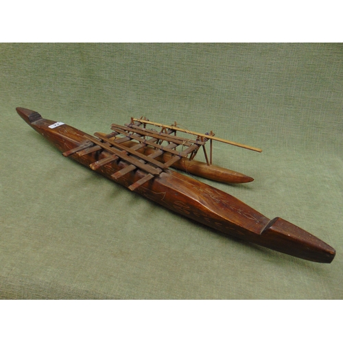 22 - Fijian carved wooden model of a native canoe with outrigger.