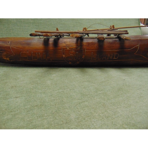 22 - Fijian carved wooden model of a native canoe with outrigger.