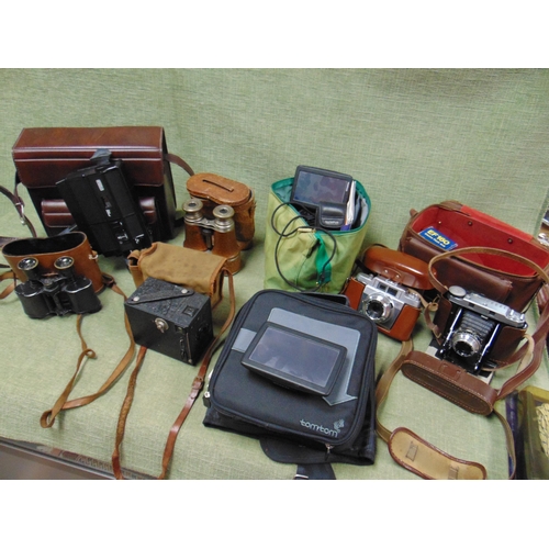 25 - Two pairs of vintage binoculars, various sat navs, cameras etc.