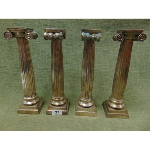 27 - Set of four plated Ionic column candlesticks.