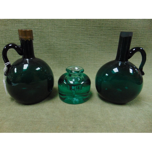 109 - Pair of antique green glass jugs, of bulbus form, together with a green glass ink well. (3).