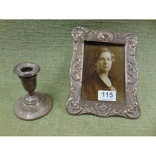 115 - Silver mounted Art Nouveau photograph frame , together with a silver squat form candle stick. (2).