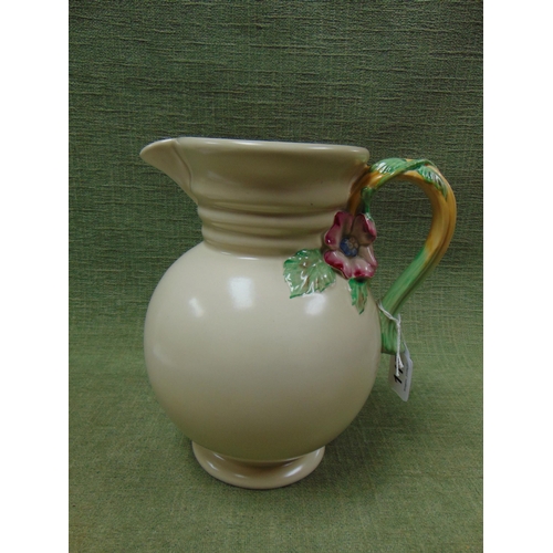 117 - Clarice cliff jug, having ribbed neck and flower form handle.