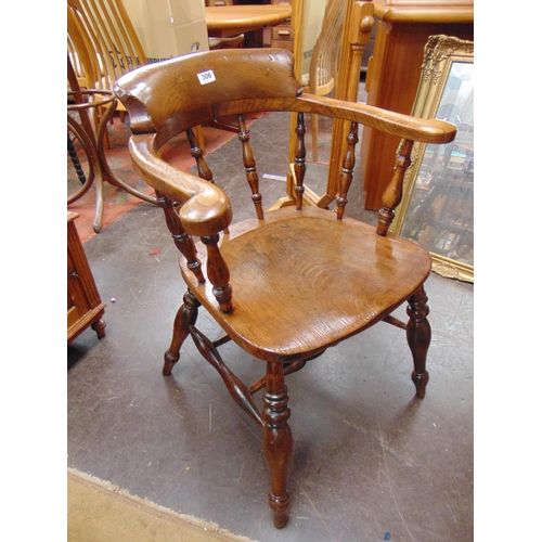 306 - Antique elm captains chair, open arms, spindle back, solid seat on turned supports and H -shaped str... 