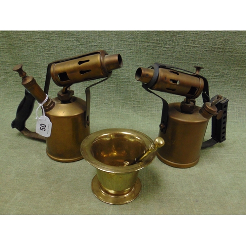 50 - Two brass blow lamps, together with a brass pestle and mortar.